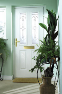 white entrance door plant
