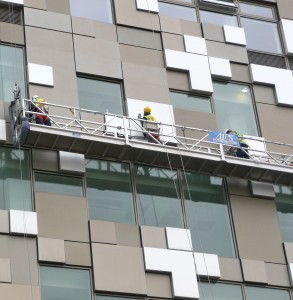 Glazing professionals working on exterior of building